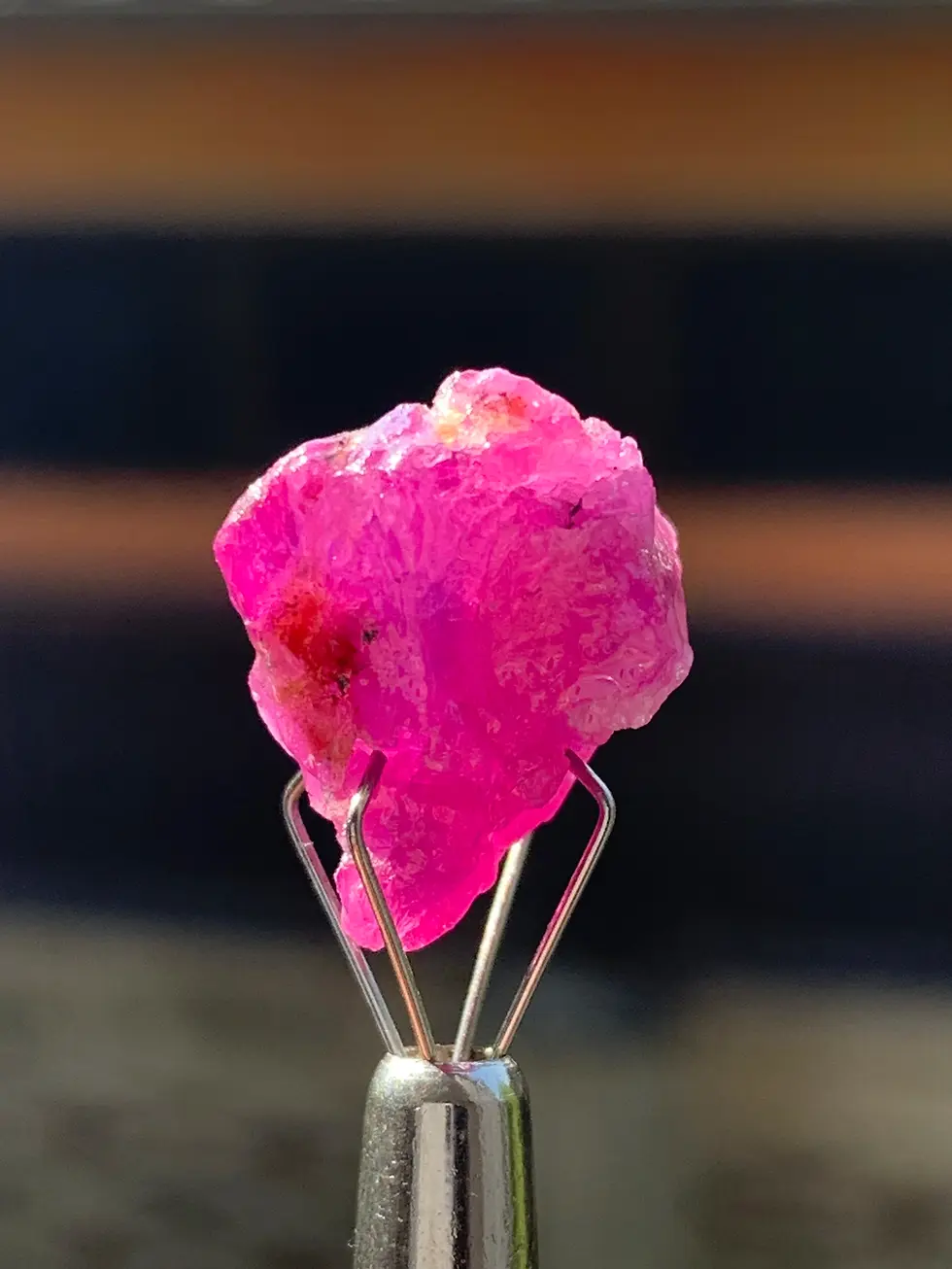 Cristal de rubis brut magenta de Jegdalek, structure opaque naturelle avec faces de croissance visibles, origine Afghanistan.