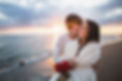 smiling-couple-walking-beach-with-bouquet-roses-sunset.jpg
