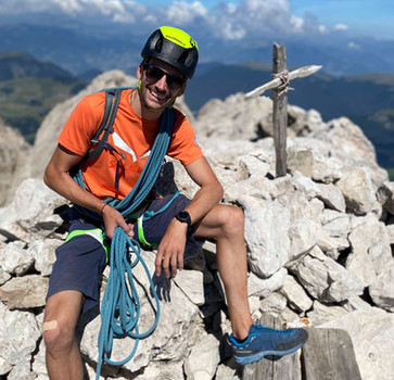 Mountain guide on the summit of Sassolungo in the Dolomites