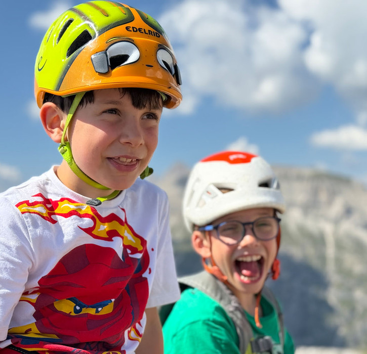 Children on Via Ferrata Piccolo Cir in the Dolomites near Passo Gardena
