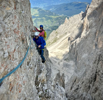 Climber on exposed chimney section on Punta Cinque Dita