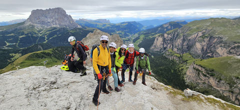 Grande Cir with panoramic views over Val Gardena, the Sella Group and Passo Gardena.
Climbers on Via Ferrata Grande Cir above Gardena Pass