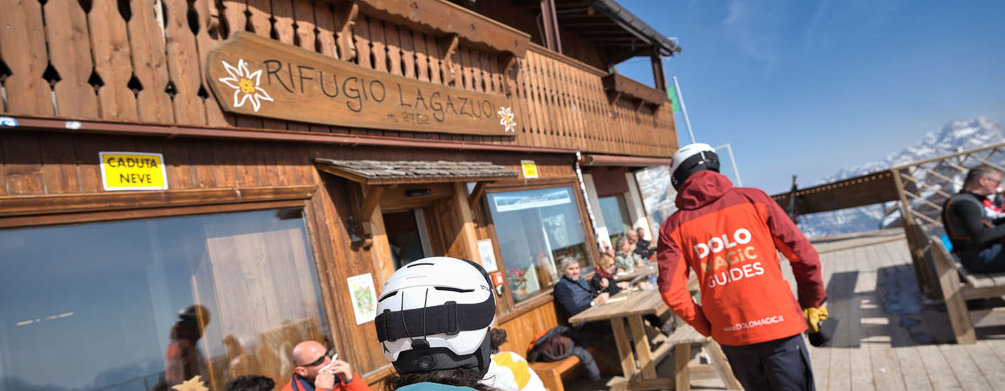 Skiers stopping at Rifugio Lagazuoi with panoramic views over Cortina d’Ampezzo and Dolomites mountains