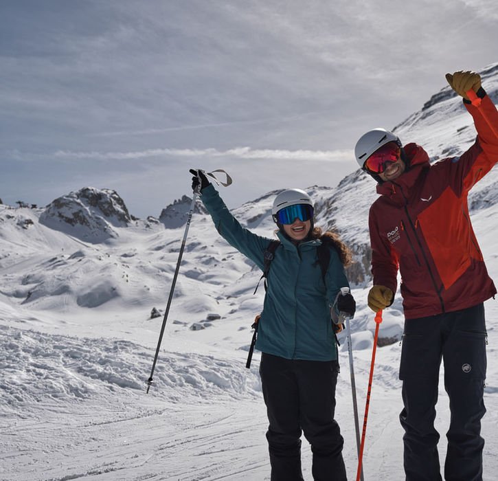 Ski guide and skiers on snowy slopes near Cortina d'Ampezzo