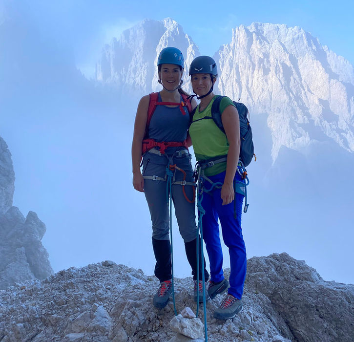 Climbers on the summit of Sassolungo in the Dolomites with mountain guide