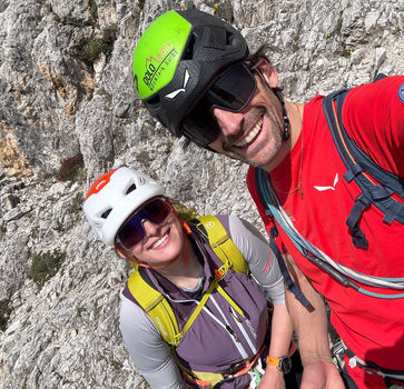 Mountain guide and climber smiling on Via Ferrata Sottotenente Fusetti