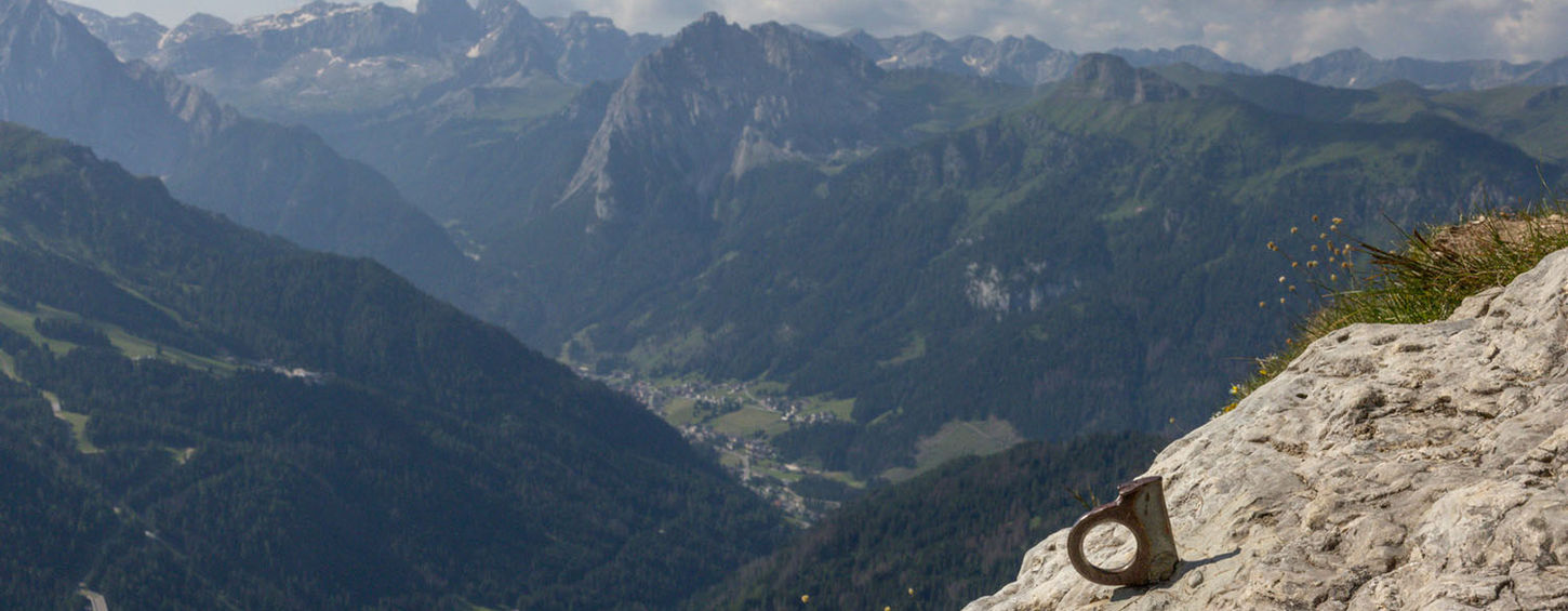 Traditional piton fixed in rock on Dolomites climbing route showing classic alpine climbing protection