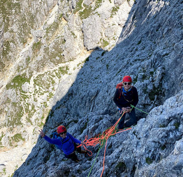 Climbers on steep limestone wall on Torre Piccola del Falzarego