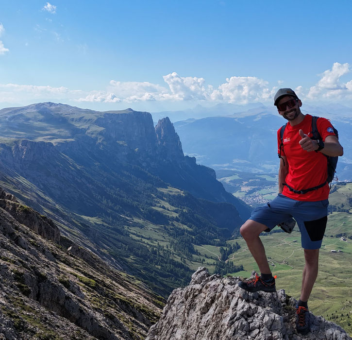 Climber enjoying panoramic views on Via Ferrata Maximilian at Alpe di Siusi
