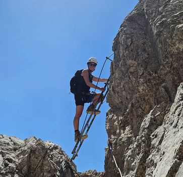 Exposed ladder climbing on via ferrata Monte Paterno Dolomites