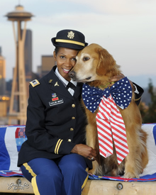 Shanda Taylor-Boyd, of Sammamish, poses with her service dog Ranger on Queen Anne Hill with the city backdrop.