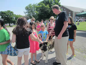Students and parents always surround Cole and Spartacus, probably the most identifiable therapy-dog team in Newtown. The pair was there to help from the day of the shootings until June 21, the final day of school.