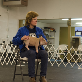 Amy and Stock watch while the instructor demonstrates an exercise during class.