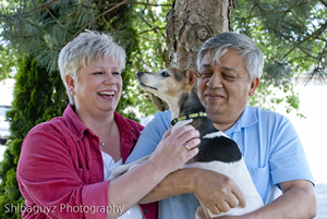 While owner Manny Gomez holds Lucy, the dog tries to give Gomez's wife, Lori Massie, a kiss on the cheek.