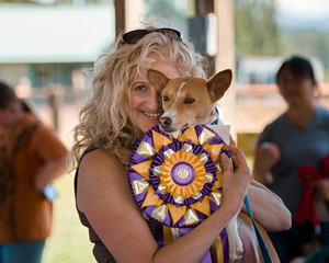 To the victor go the rewards.  Campbell holds Naziki and a rosette after the African-native dog won Best of Breed in the American Kennel Club lure coursing trial at the Basenji Club of America National Specialty.  The lure trial is the closest emulation the national club has to a hunt  – which showcases the preservation of the breed’s natural instinct and purpose. 