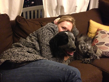 On a cold winter evening, Herz and Jackson cuddle on the couch in their black-and-gray “outfits.” 