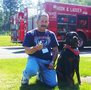 Steve Berko and his 5-year-old Rottweiler Dascha, were popular regulars at Reed Intermediate School following the shootings. Berko's family were neighbors to the shooter, Adam Lanza's, family. "I've seen the worst in humanity but the best in a community coming together," he said.