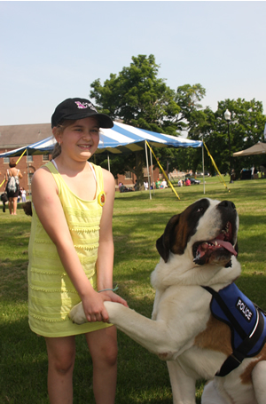 Samantha Kuruc is all smiles while enjoying some bonding time with Clarence, a St. Bernard, owned by Bill and Laura Gordon, of Greenfield, Mass. The couple, both members of the Greenfield police department, operates an organization called Canines Helping Autism and PTSD Survivors. Their two St. Bernards, Clarence and Rosie, also compete in conformation shows in the Northeast.