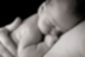 a sleeping baby being held