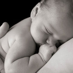 1 month old baby posing with parents for a photo shoot - Best photographers in Dubai.