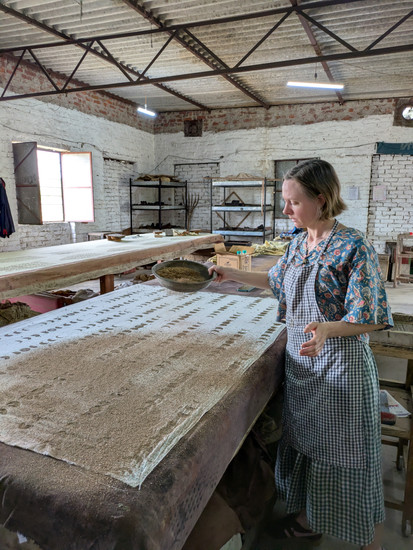 Covering the printing with sawdust to help it dry and stop it sticking