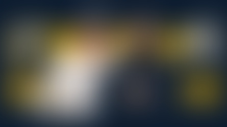 Coaches in Notre Dame attire stand against a dark background, flanked by two football players in white and gold uniforms, focused expressions.