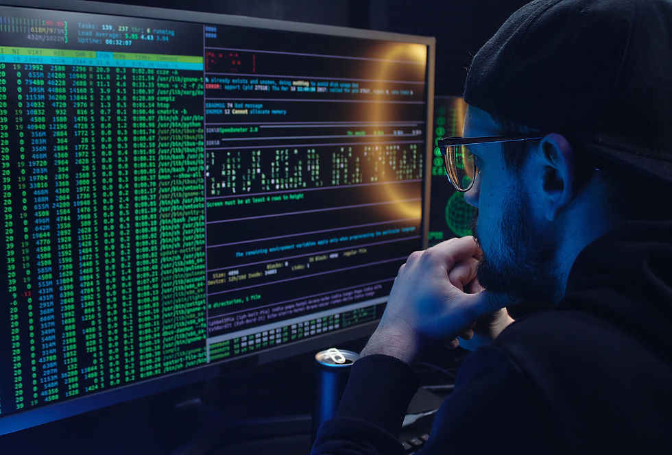 An image of a hacker looking at a screen filled with code