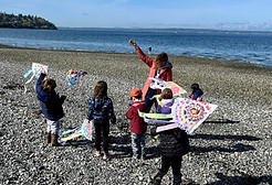 Cosmopolitan Kids teacher with Pre-K children playing at the beach in Seattle