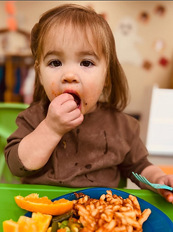 Waddler eating at Cosmopolitan Kids daycare in Seattle
