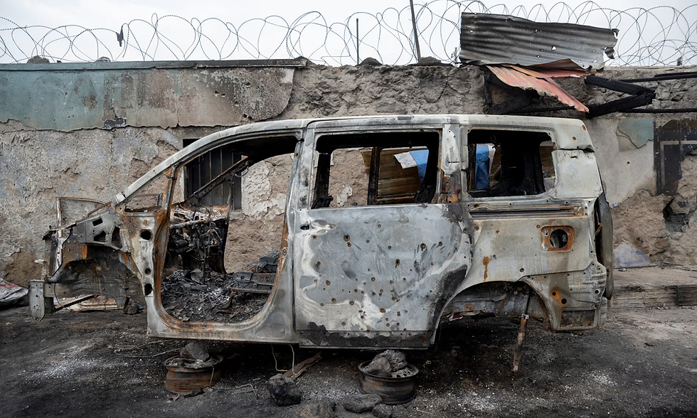 Residents survey damage from fighting between M23 rebels and Congolese forces in Goma. Photograph: Arlette Bashizi/Reuters