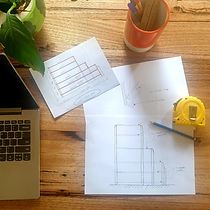 birds eye view of a desk with design sketches on it