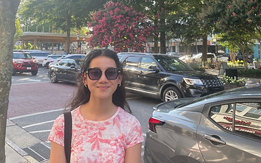 Science writer Sarah Matysiak standing in front of a blooming tree