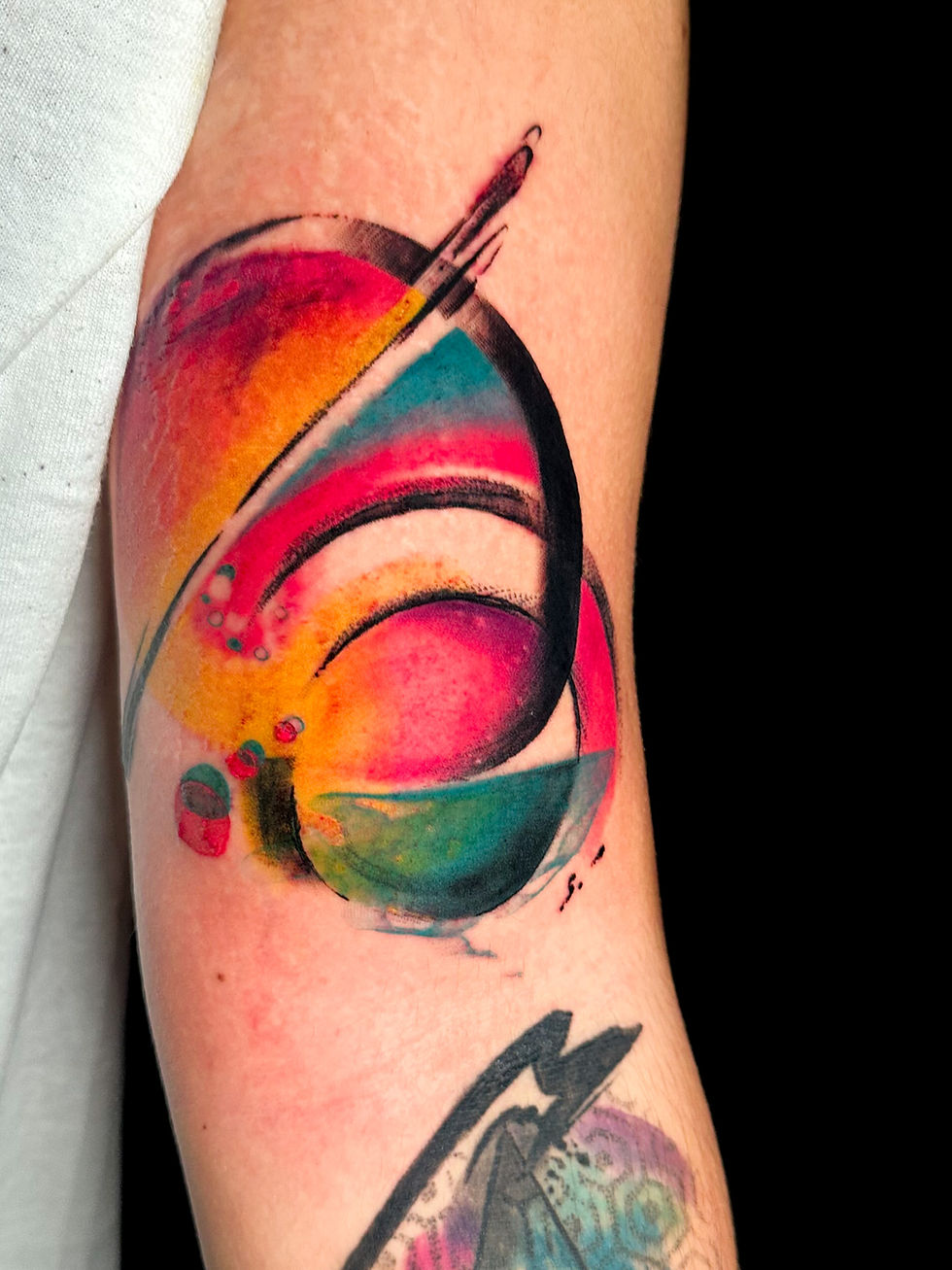 Close-up view of fresh tattoo on forearm showing vibrant ink and slight redness