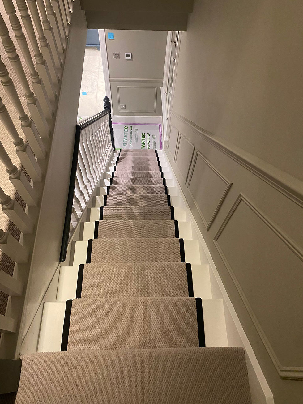 Staircase carpet fitting in a London property by Shelby Flooring