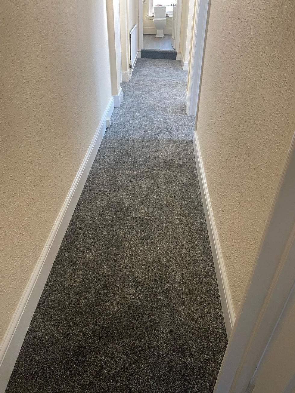 Hallway carpet fitting in a London property by Shelby Flooring