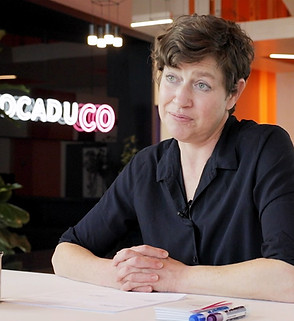 A woman with short hair sitting at a desk.