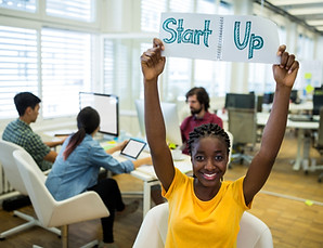 portrait-female-business-executive-holding-start-up-sign.jpg
