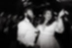 A bride and groom celebrate at their wedding reception.