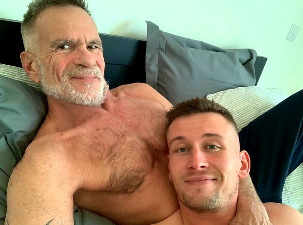 Age gap relationship couple, Mike and Aaron comfy in bed.