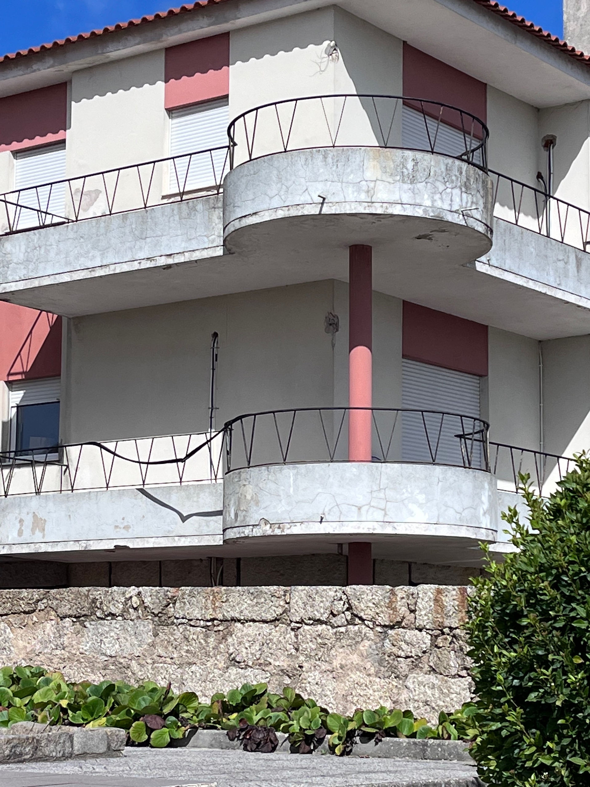 Exterior view of a modern building with balconies and stone wall Portugal Travel