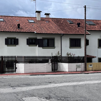 White building with red roof and black shutters, Portugal Travel