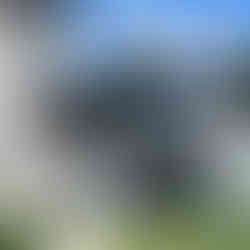 Modern building with glass windows and reflections, exterior detail, central Portugal.