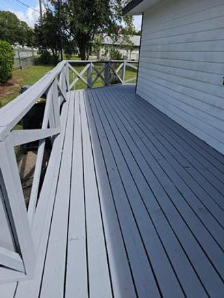 A photo showcasing a 5th alternate view of the spectacular, fully restored, hand-painted wraparound deck and accessibility ramp.