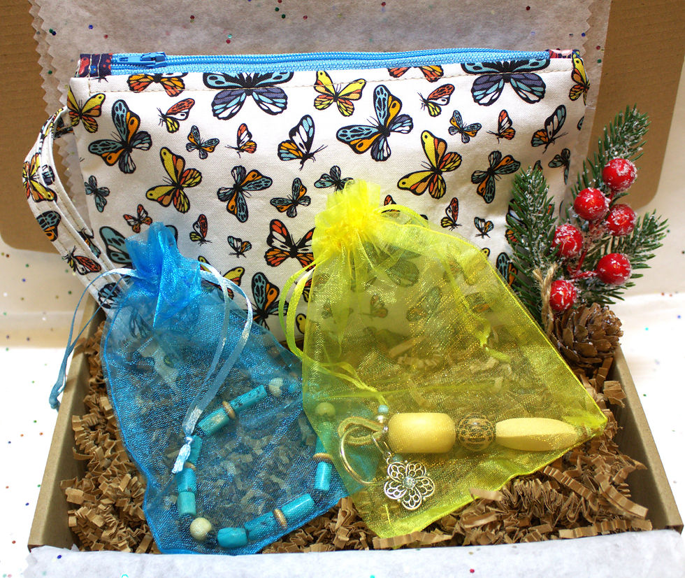 Makers medley gift box includes, zipperd hand bag with butterfly print, turquoise beaded bracelet, and wooden beaded keychain