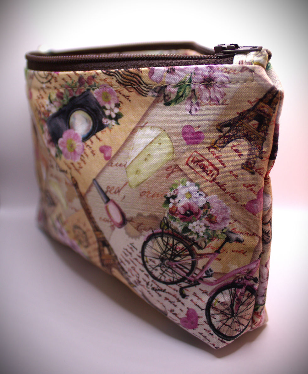 Zippered pouch approx. 8 inch wide by 6 inch. length, with wrist strap. White with Icons of France collaged pattern with bunches of flowers, and bicycles, matching maroon colored zipper.