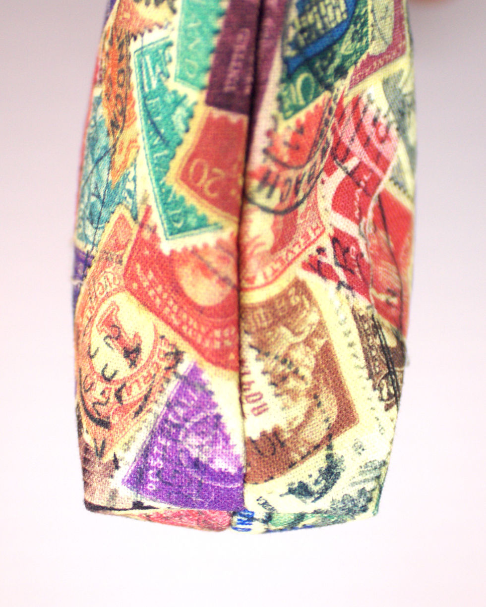 Thumbnail: Zippered wristlet hand bag with postage stamp print fabric