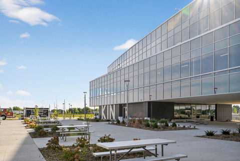 Modern building with glass facade and outdoor seating