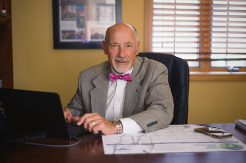 Man with pink bow tie in commercial real estate office