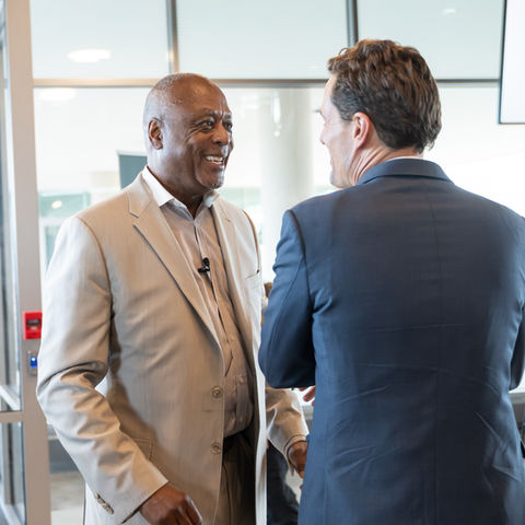 Two men conversing in a professional setting