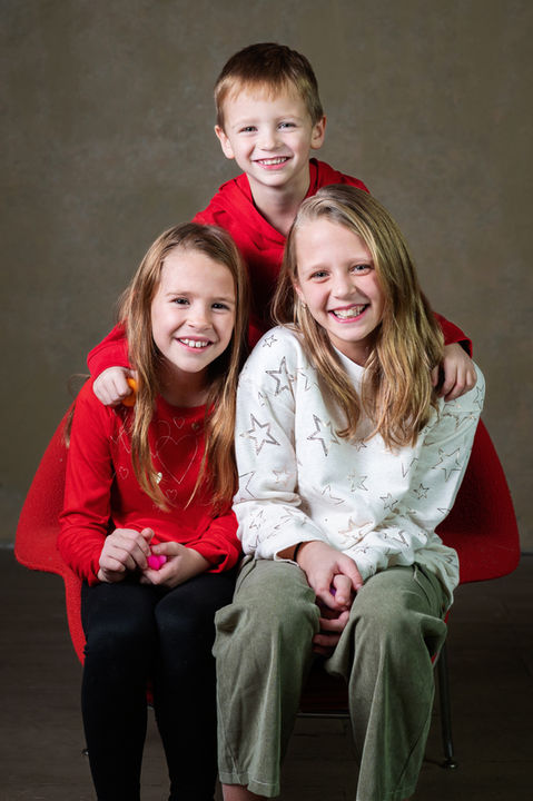Two girls and a boy smiling